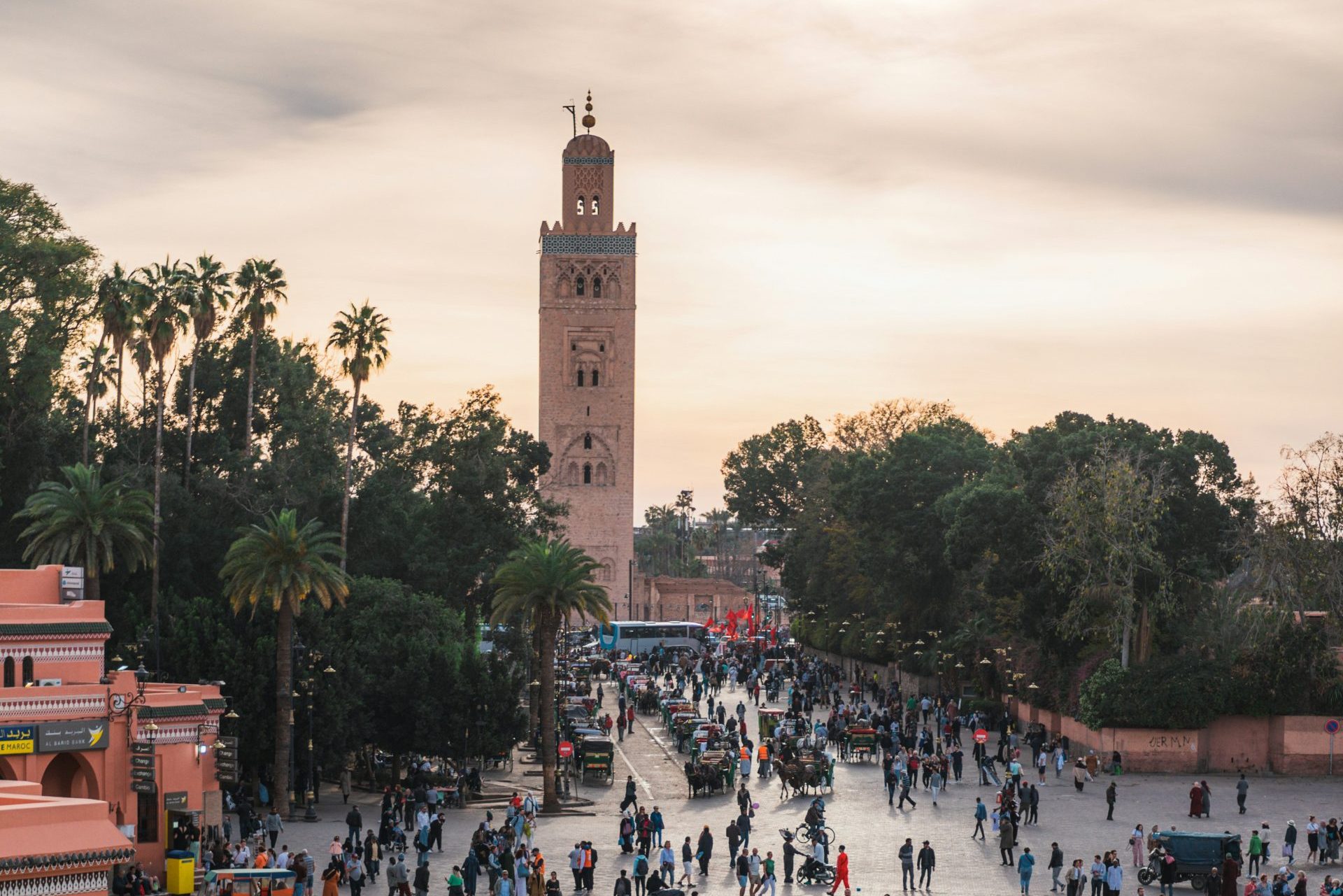 a large group of people walking around a plaza